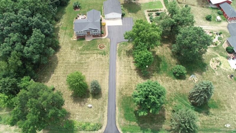 Aerial residential long asphalt driveway with turnaround